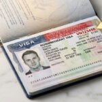 US H-1B visa stamp in passport showing visa number location highlighted in red